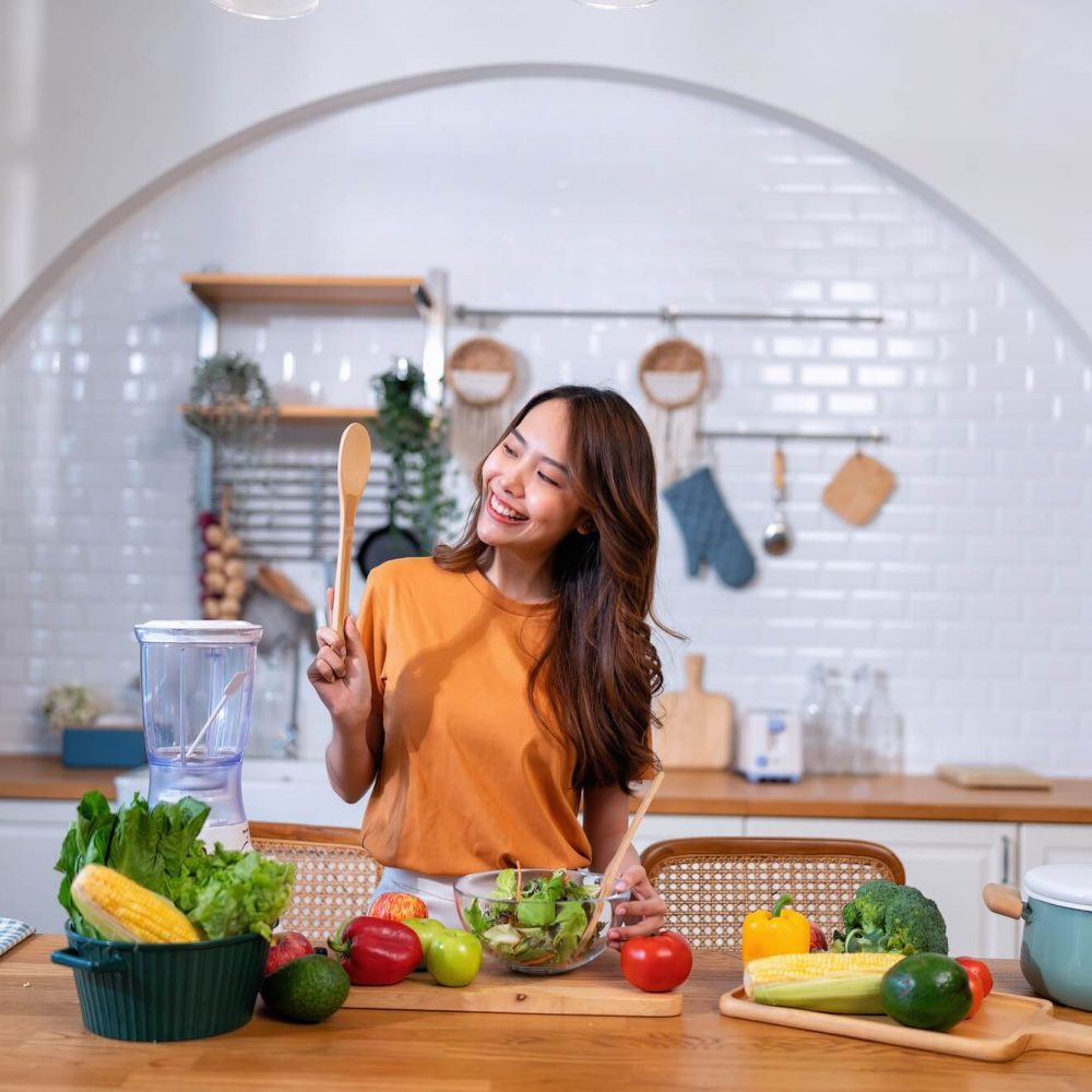 beautiful-young-woman-happy-portrait-cooking-fresh-organic-clean-food-fruit-at-home-modern-kitchen.jpg